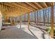 Covered patio with wood beams, providing shade and a view of the backyard's fire pit at 2415 Roxburgh Dr, Roswell, GA 30076