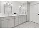 Bathroom featuring a double sink vanity with quartz countertops and white hexagon tile flooring at 2415 Roxburgh Dr, Roswell, GA 30076