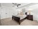 Spacious bedroom featuring a ceiling fan, neutral carpet, and two closets at 2415 Roxburgh Dr, Roswell, GA 30076