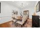 Formal dining room with hardwood floors, decorative chandelier, and large window at 2415 Roxburgh Dr, Roswell, GA 30076