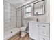 Well-lit bathroom features sleek white vanity, modern fixtures, and a glass enclosed shower at 5205 Silhouette Sw Ln, Mableton, GA 30126