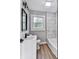 Stylish bathroom boasts modern vanity, sleek fixtures, and glass enclosed shower at 5205 Silhouette Sw Ln, Mableton, GA 30126
