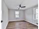 Cozy bedroom featuring a ceiling fan, wood-look flooring, and bright windows at 5205 Silhouette Sw Ln, Mableton, GA 30126