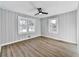 Inviting bedroom with neutral walls, wood-look floors, and ample natural light from bright windows at 5205 Silhouette Sw Ln, Mableton, GA 30126
