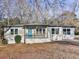 Charming ranch-style home featuring a covered front porch with a bright blue front door at 5205 Silhouette Sw Ln, Mableton, GA 30126