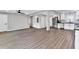 Open concept living area featuring stainless steel appliances, white cabinets, and vinyl plank flooring at 5205 Silhouette Sw Ln, Mableton, GA 30126