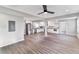 Open concept living room boasts neutral paint, modern ceiling fan, and vinyl plank flooring at 5205 Silhouette Sw Ln, Mableton, GA 30126