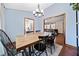 Bright dining room with hardwood floors, modern lighting, and ample space for entertaining guests at 603 Savannah Way, Woodstock, GA 30189