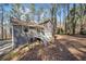 Back exterior of house with deck, stairs, wooded setting at 603 Savannah Way, Woodstock, GA 30189