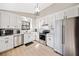 Stylish kitchen featuring stainless steel appliances, granite countertops, and plenty of natural light at 603 Savannah Way, Woodstock, GA 30189