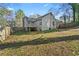 Spacious backyard featuring a gray wooden deck and partial fence at 649 Woodcrest Manor Dr, Stone Mountain, GA 30083