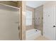 Clean bathroom with a glass-enclosed shower over tub and updated tile work at 649 Woodcrest Manor Dr, Stone Mountain, GA 30083