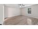 A bright bedroom featuring a ceiling fan and new laminate flooring at 649 Woodcrest Manor Dr, Stone Mountain, GA 30083