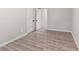 An empty bedroom with new laminate flooring and freshly painted walls at 649 Woodcrest Manor Dr, Stone Mountain, GA 30083