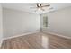 A bright bedroom featuring a ceiling fan and new laminate flooring at 649 Woodcrest Manor Dr, Stone Mountain, GA 30083