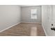 An empty bedroom with new laminate flooring and freshly painted walls at 649 Woodcrest Manor Dr, Stone Mountain, GA 30083