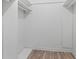 Empty closet featuring new white shelving and laminate flooring at 649 Woodcrest Manor Dr, Stone Mountain, GA 30083
