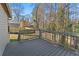 Exterior view of a gray deck and a fenced yard in a wooded setting at 649 Woodcrest Manor Dr, Stone Mountain, GA 30083