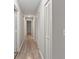 Hallway featuring wood flooring and multiple linen closets with vented doors at 649 Woodcrest Manor Dr, Stone Mountain, GA 30083