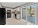 Well-equipped kitchen with white cabinets, black appliances, and a sliding door to a deck at 649 Woodcrest Manor Dr, Stone Mountain, GA 30083