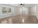 Well-lit living room with hard wood flooring, ceiling fan, neutral colored walls and a large window at 649 Woodcrest Manor Dr, Stone Mountain, GA 30083