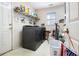 Functional laundry room features modern washer and dryer, storage shelving, and convenient access at 11 Tallulah Ct, Jonesboro, GA 30236