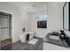 Well-lit bathroom with walk-in closet, a freestanding tub, and patterned floors at 2014 Cambridge Ave, Atlanta, GA 30337