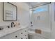 Bright bathroom featuring marble vanity and tiled shower-tub combo at 2014 Cambridge Ave, Atlanta, GA 30337