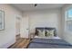 Bright bedroom with hardwood floors, neutral walls, and a cozy bed at 2014 Cambridge Ave, Atlanta, GA 30337