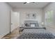 Bright bedroom featuring hardwood floors, neutral walls, and a large comfortable bed with a decorative blanket at 2014 Cambridge Ave, Atlanta, GA 30337