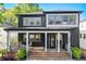 Stunning two-story home featuring a modern exterior with a covered porch and inviting entryway at 2014 Cambridge Ave, Atlanta, GA 30337