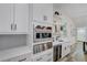 Gourmet kitchen featuring stainless steel appliances, a wet bar and custom cabinetry at 2014 Cambridge Ave, Atlanta, GA 30337