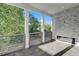 Covered patio with stone fireplace, offering serene outdoor living with lush greenery views at 2014 Cambridge Ave, Atlanta, GA 30337