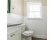 The bathroom has white wall tiles, a granite countertop, and a stylish faucet and is well-lit with natural light at 2818 Mcafee Rd, Decatur, GA 30032