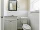 Bright bathroom featuring a framed mirror and white tiled walls, creating a clean and inviting space at 2818 Mcafee Rd, Decatur, GA 30032