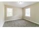 A light-filled bedroom with two windows and plush carpeting, creating a comfortable and inviting space at 2818 Mcafee Rd, Decatur, GA 30032