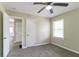 Carpeted bedroom featuring a ceiling fan and natural light from a window with access to hallway and closet at 2818 Mcafee Rd, Decatur, GA 30032