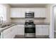 Bright kitchen with white cabinets, granite countertops, and stainless steel appliances at 2818 Mcafee Rd, Decatur, GA 30032