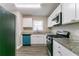 The spacious kitchen features granite countertops and stainless steel appliances at 2818 Mcafee Rd, Decatur, GA 30032