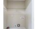 An empty laundry room with utility connections, ready for your appliances, and a shelf for storage at 2818 Mcafee Rd, Decatur, GA 30032