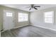 Bright living room with new vinyl floors, a ceiling fan, and a door to the exterior at 2818 Mcafee Rd, Decatur, GA 30032