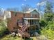 The brick home features an elevated deck, screened porch and stairs leading to the backyard at 301 Millbrook Farm Ct, Marietta, GA 30068