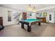 Finished basement with a pool table, two windows, exposed stairs, and bar seating, making it great for entertaining at 301 Millbrook Farm Ct, Marietta, GA 30068