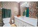 Bathroom features a white vanity, a large mirror, a toilet, and colorful wallpaper, creating a unique space at 301 Millbrook Farm Ct, Marietta, GA 30068