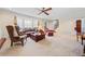 Spacious living room featuring a bay window, neutral walls, and access to the staircase at 301 Millbrook Farm Ct, Marietta, GA 30068