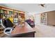 Bright home office featuring custom wood bookshelves, an oversized wood desk, and a cozy reading chair at 301 Millbrook Farm Ct, Marietta, GA 30068