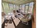 Bright sunroom with multiple windows, seating, and treetop views at 301 Millbrook Farm Ct, Marietta, GA 30068