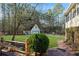 This backyard has an outbuilding, mature trees, expansive green grass and brick walkway at 326 Bethel Dr, Woodstock, GA 30189