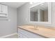 Bathroom featuring neutral walls, white sink with vanity, and a framed mirror at 326 Bethel Dr, Woodstock, GA 30189
