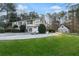 Spacious home featuring a well-kept lawn, mature trees, and a detached garage at 326 Bethel Dr, Woodstock, GA 30189